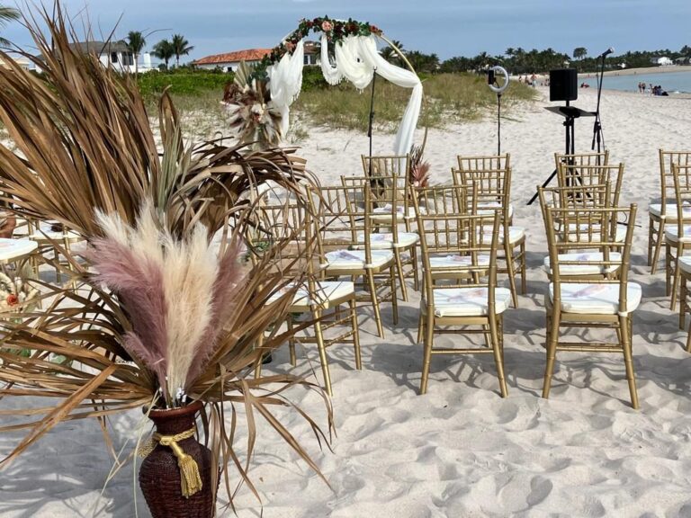 Beach ceremony aisle lined with pampas grass and chiavari chairs