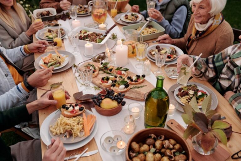 Backyard dinner party table with candles, grazing boards and wine